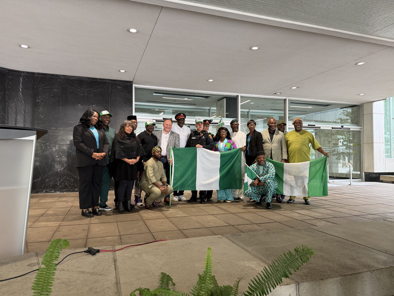 Hamilton Police Chief Frank Bergen with Hamilton’s Nigerian community and a Nigerian flag at the Nigeria Independence Day celebration at City Hall