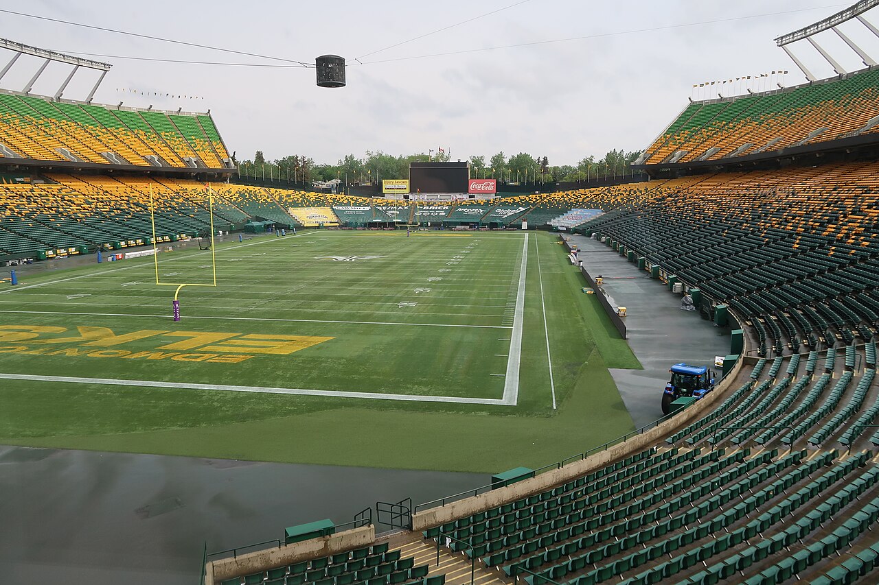 Commonwealth Stadium’s football field and empty stands in June 2022 by Urban Versis 32; file photograph, not the October 16 game